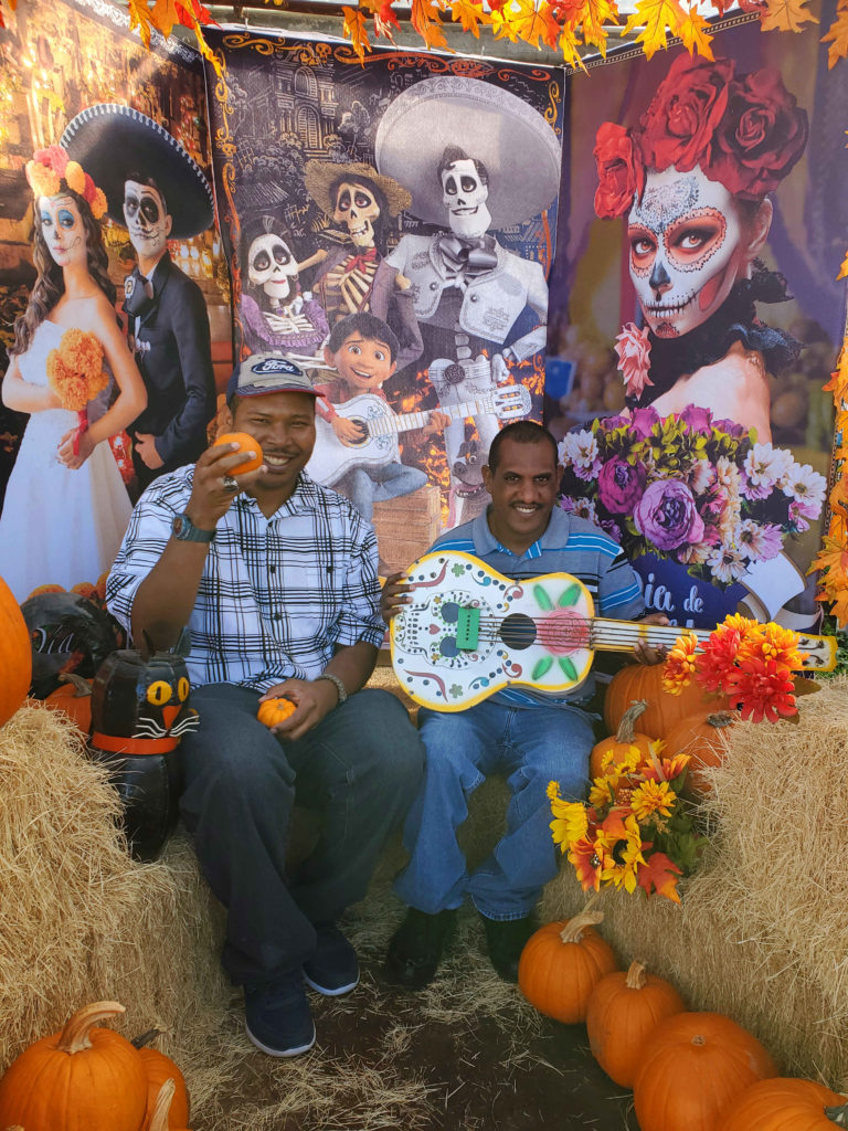 Customers with metal Halloween garden decorations, pumpkins and hay bales!